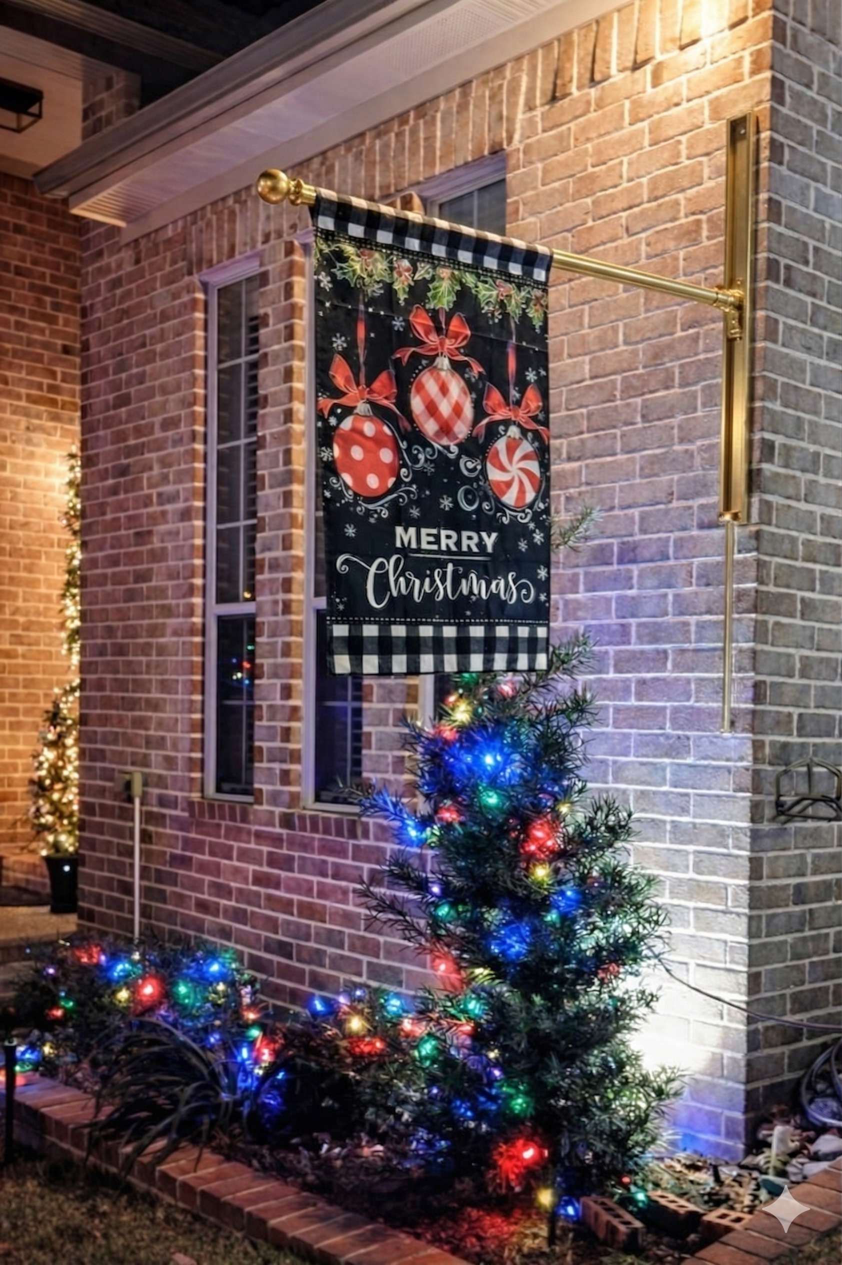 Gold VersaMAST System displaying Merry Christmas holiday flag at night